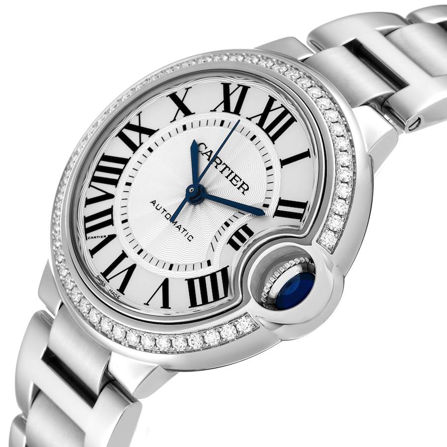 This image showcases the face, crown, and part of the bracelet of the Cartier Ballon Bleu watch at an angled view.