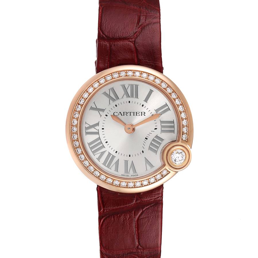 This image shows a Ballon Bleu model by Cartier from a top-down angle, featuring a round face, Roman numerals, and a red leather strap.