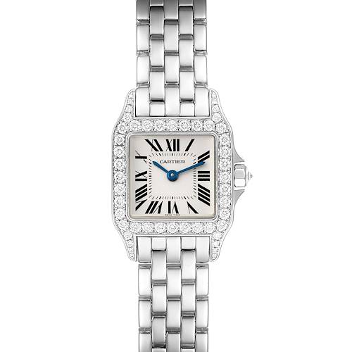 The image shows a frontal view of the Cartier Santos Demoiselle watch, highlighting its square face, Roman numerals, blue hands, diamond bezel, and metal bracelet.