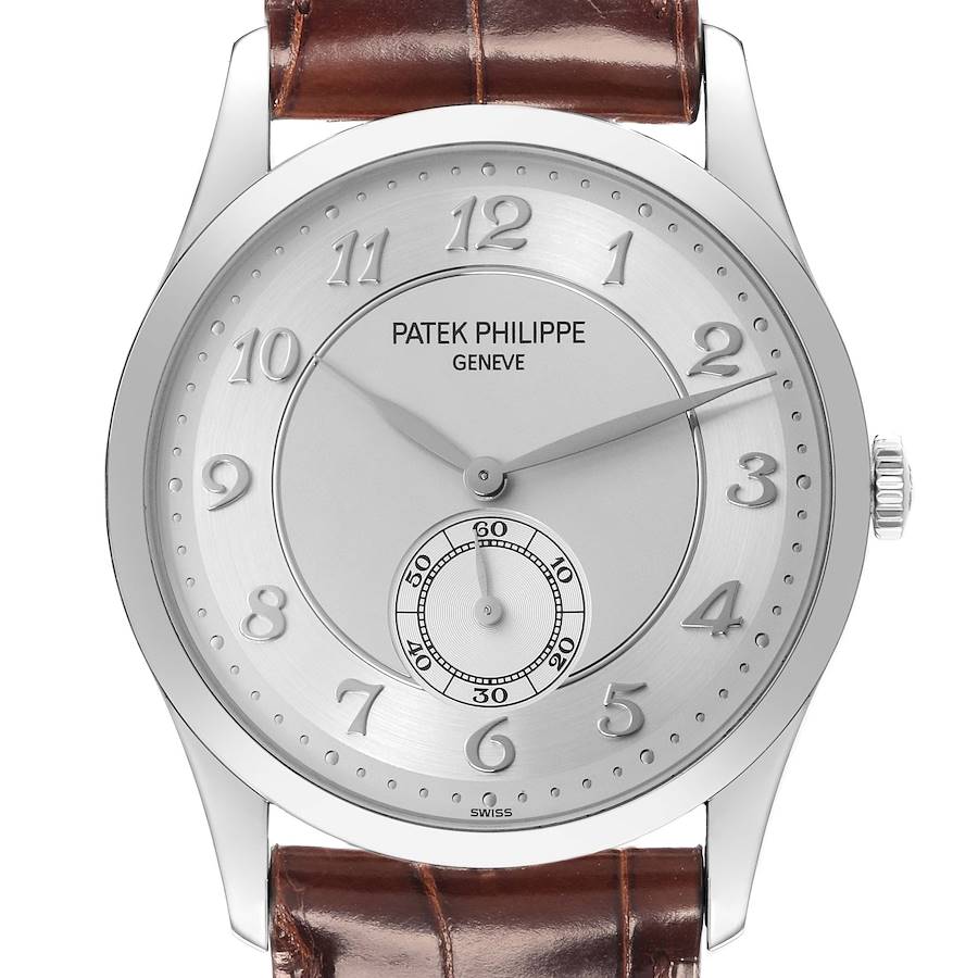 The Patek Philippe Calatrava watch is shown from a front angle, displaying the face, dial, and partial leather strap.