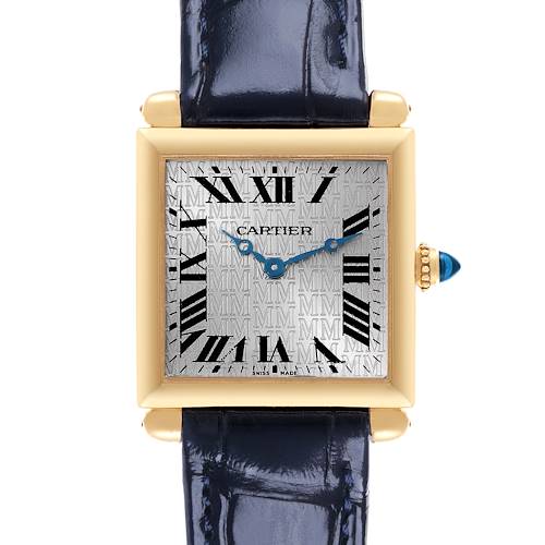 The Cartier Tank Obus watch is shown from the front, displaying its square dial, Roman numerals, and blue strap.