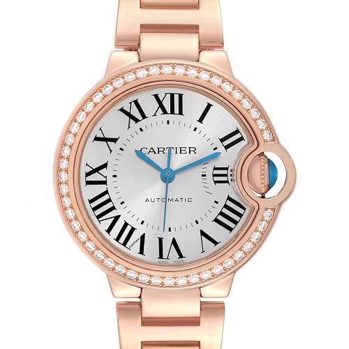The Cartier Ballon Bleu watch is shown from the front, highlighting the face, Roman numerals, and diamond-set bezel.