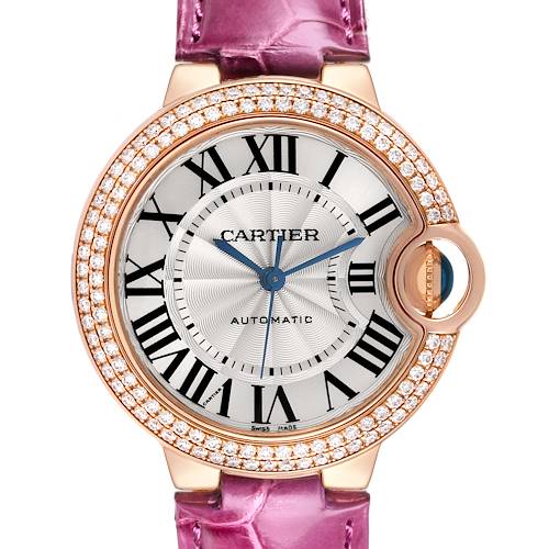 The Cartier Ballon Bleu watch is shown from the front, displaying its face, bezel, and pink leather strap.