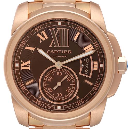The Calibre de Cartier watch is shown from the front, highlighting the dial, hands, and bezel.