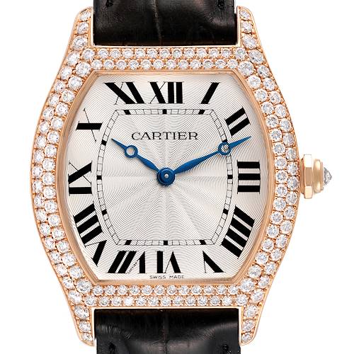 The image shows a close-up, front view of a Cartier Tortue watch with a diamond-encrusted bezel and black leather strap.