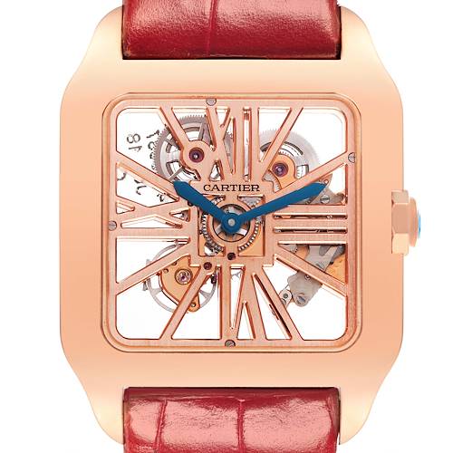 The Cartier Santos model is shown from the front, highlighting its skeleton dial, blue hands, and red leather strap.