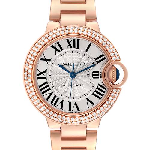 The Cartier Ballon Bleu watch is shown from the front, displaying the face, Roman numerals, diamond bezel, and part of the bracelet.