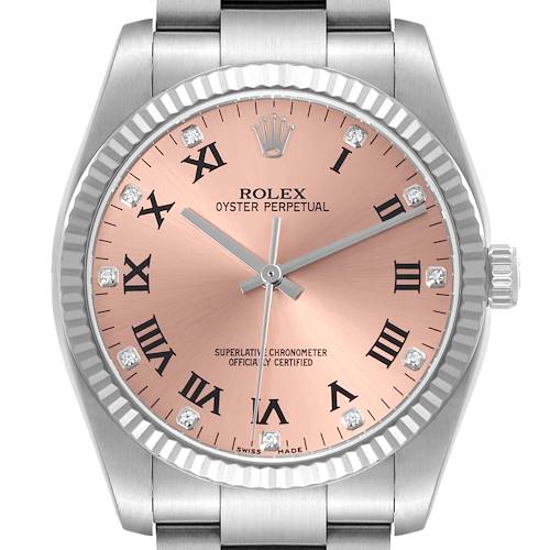 The image shows a Rolex Oyster Perpetual watch face straight-on, highlighting its pink dial, Roman numerals, and diamond markers.