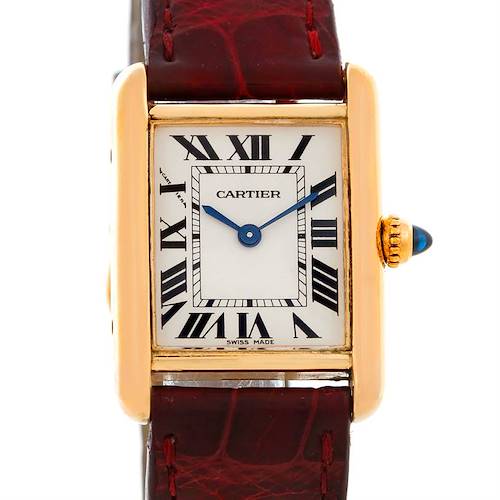 The image shows a front view of a Cartier Tank Louis watch with a red leather strap and gold case.