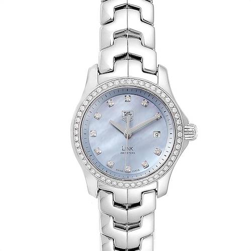 The Tag Heuer Link watch is shown from a top-down angle, highlighting the dial, bezel, and bracelet.