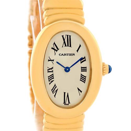 This image shows a Cartier Baignoire watch with a gold case, Roman numerals, blue hands, and a beaded crown with a blue cabochon.