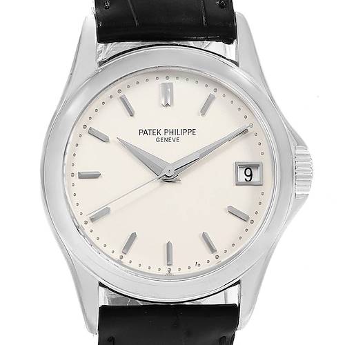 The image shows a frontal view of the Patek Philippe Calatrava watch, showcasing its dial, hands, markers, and date window.