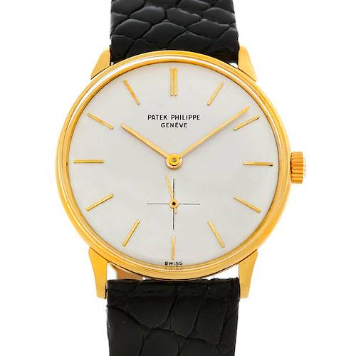 The image shows a front view of the Patek Philippe Vintage model watch, highlighting its gold case, white dial, and black leather strap.