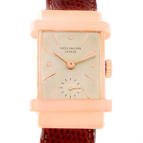 The image shows a front view of a Vintage Patek Philippe watch, highlighting its rectangular face, dial, crown, and part of the leather strap.