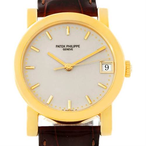 The image shows a front view of a Patek Philippe Calatrava watch, displaying the dial, hands, date window, and part of the strap.