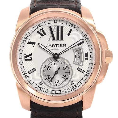 The image shows a front view of the Calibre de Cartier watch by Cartier, highlighting its dial, hands, date display, and leather strap.