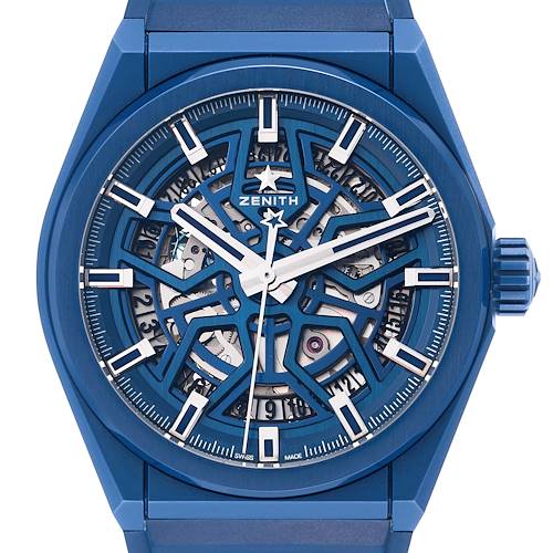 The image shows a front view of the Zenith Defy model watch, highlighting its intricate blue skeleton dial and hands.