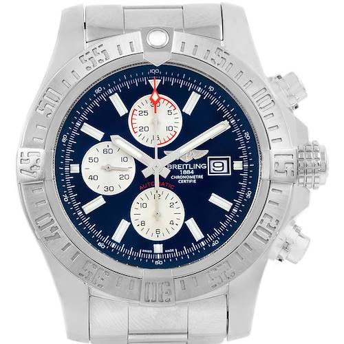 The image shows a Breitling Avenger watch with a navy blue dial, silver bezel, and metal strap, viewed from the front.