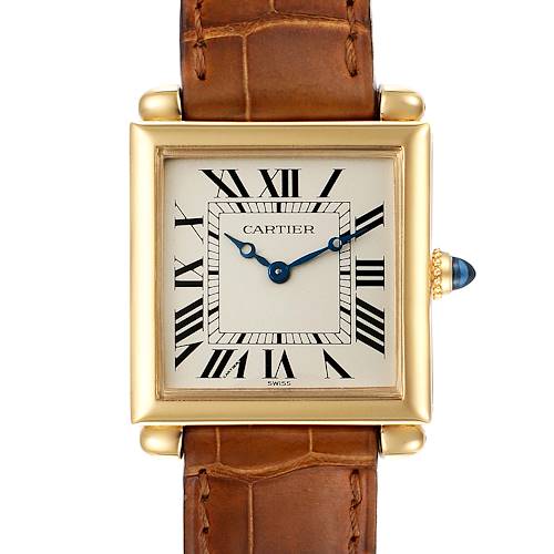 The Cartier Tank Obus watch is shown from a front angle, highlighting its square face, Roman numeral dial, and brown leather strap.