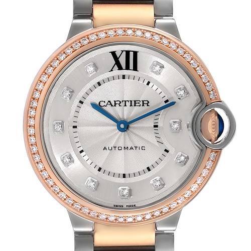 The image shows a close-up front view of the Cartier Ballon Bleu watch, highlighting its face, hands, dial, and the crown with a blue sapphire.