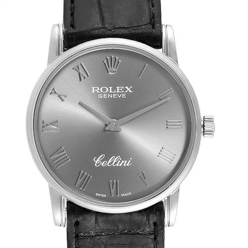 The image shows a front view of a Rolex Cellini watch, highlighting its face, crown, and part of the leather strap.