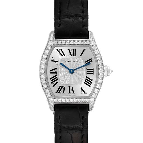The image shows a front view of the Cartier Tortue watch, featuring its face, black leather strap, and diamond-studded bezel.