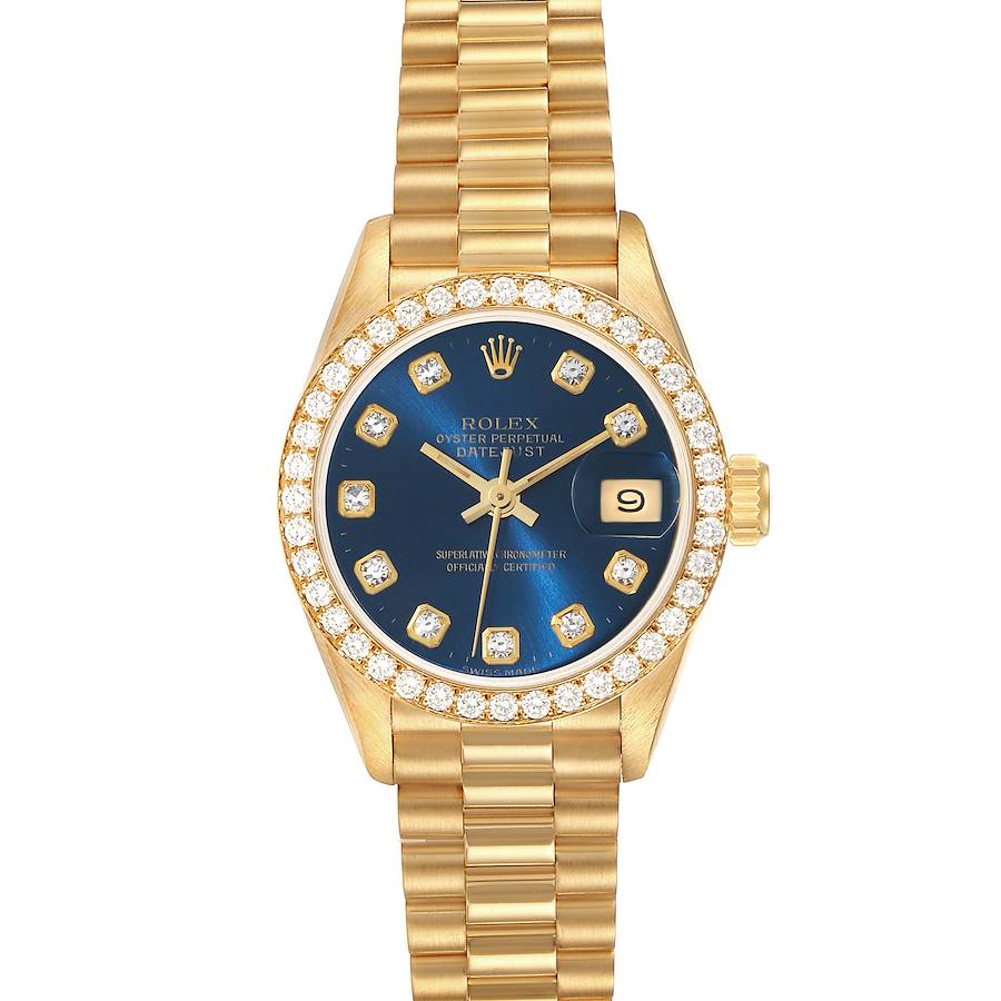 The image shows a Rolex President watch, displaying the face with a blue dial, date window, diamond markers, and gold bracelet.