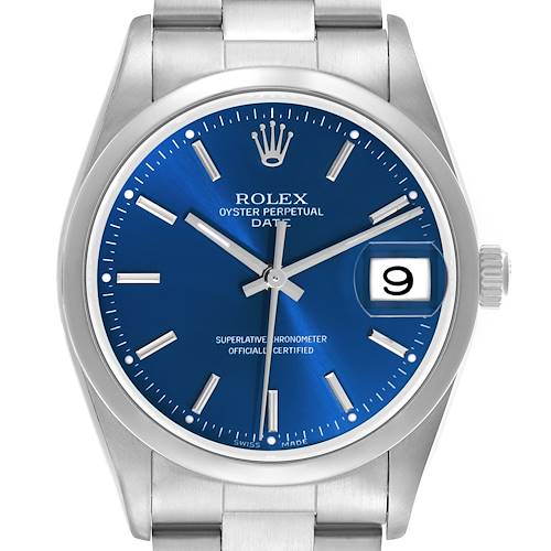 The Rolex Date watch is shown from a top-down angle, featuring its blue dial, date window, and stainless steel bracelet.