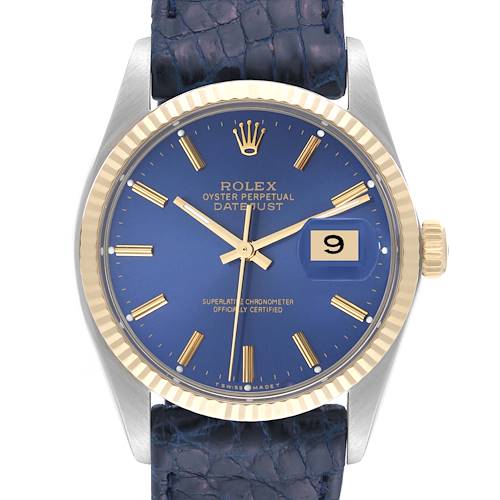 This Rolex Vintage Collection model features a blue dial, gold markers, fluted bezel, and a blue textured strap in a front view.