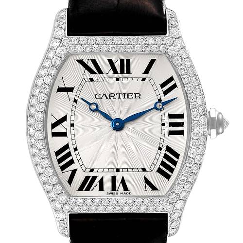 This image shows the front view of a Cartier Tortue watch, highlighting the diamond bezel, dial, and blue hands.