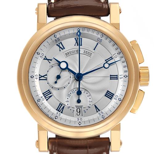 The Breguet Marine watch is shown from a front angle, highlighting the dial, hands, and leather strap.