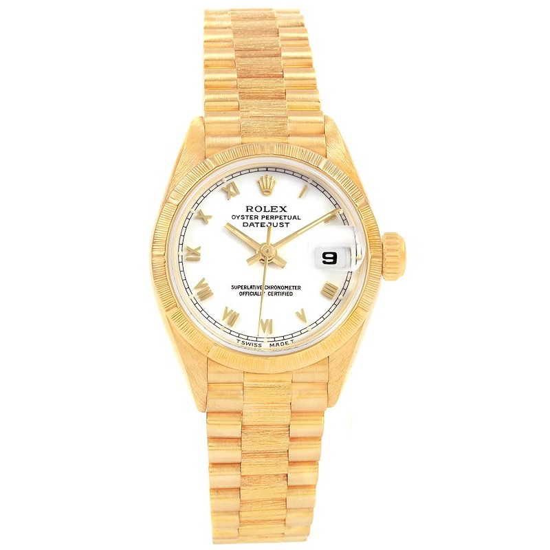 The Rolex Datejust watch is displayed from a top-down angle, showing its face, bracelet, and crown.