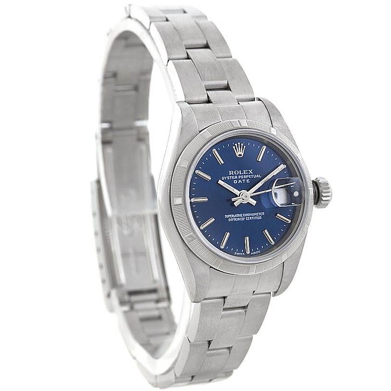 The image shows a Rolex Date model watch from a three-quarter angle, highlighting the face, bezel, and bracelet.