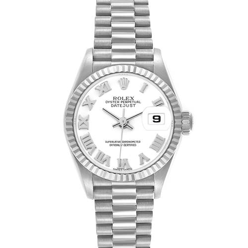 The Rolex President model is shown from a front angle, featuring its fluted bezel, bracelet, dial with Roman numerals, and date window.