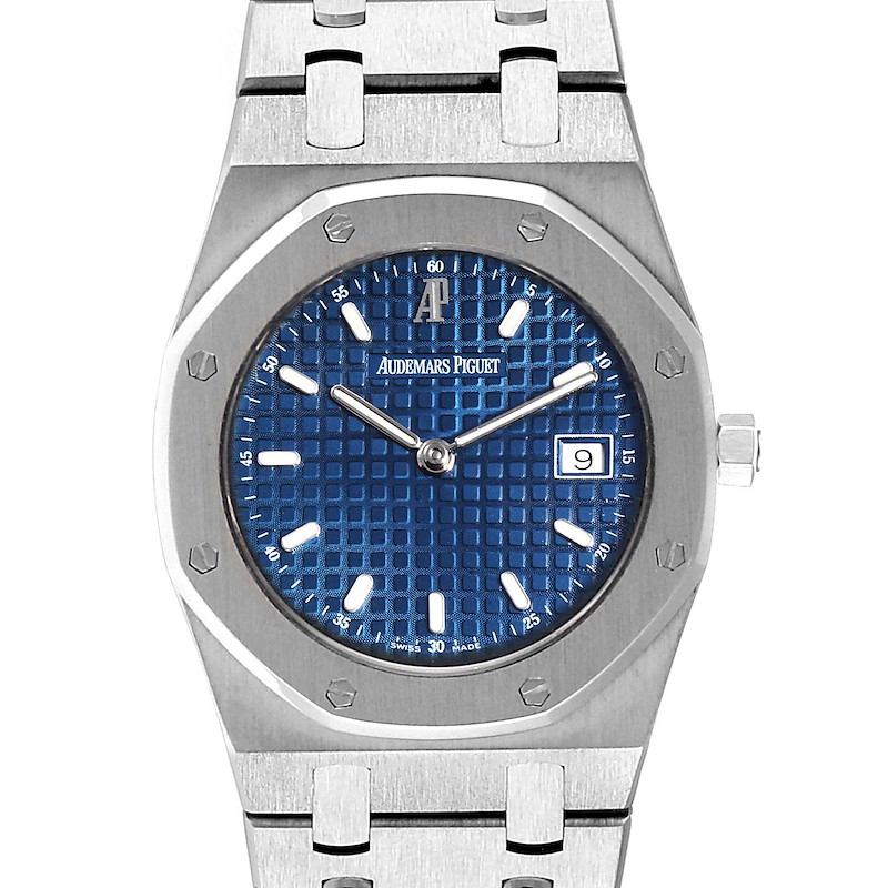 The image shows a frontal view of the Royal Oak by Audemars Piguet, highlighting its blue dial, date window, and distinctive octagonal bezel.