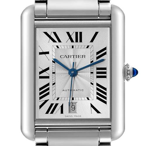 The image shows a close-up of the face of a Cartier Tank Must watch, displaying its Roman numerals, hands, date window, and crown.