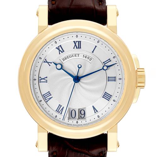 This Breguet Marine watch is pictured from the front, displaying its face, Roman numerals, blue hands, date window, and gold casing.
