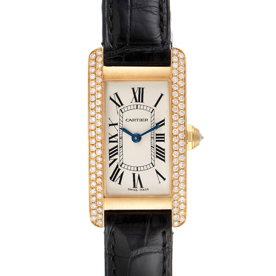 The image shows a frontal view of a Cartier Tank Americaine watch with a gold case encrusted with diamonds and a black leather strap.
