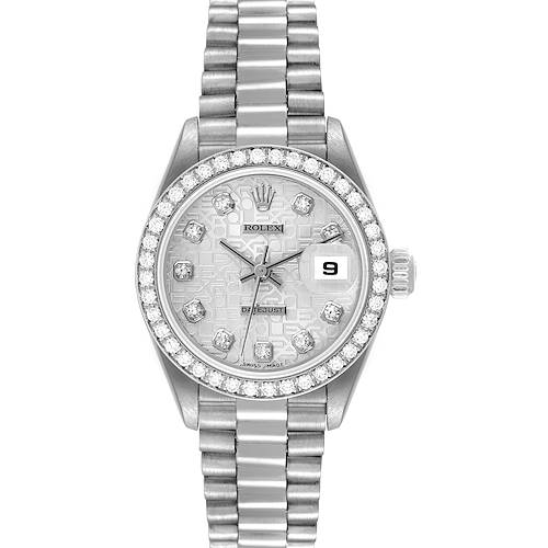 The Rolex President model watch is shown from a front angle, displaying the face, bezel, bracelet, and date window.