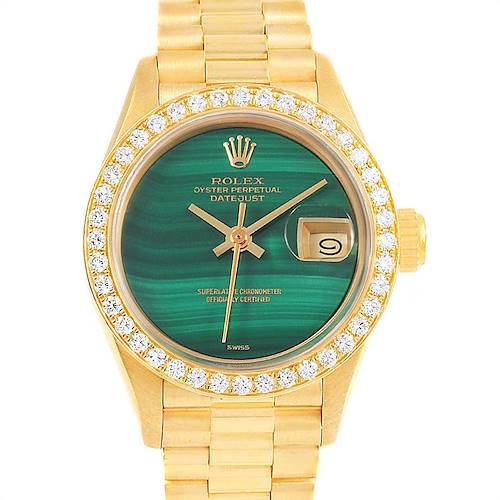 This image shows the face and band of a Rolex President model watch, highlighting its green dial, date function, and diamond bezel.
