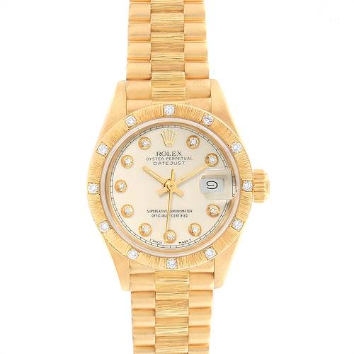 The image shows a Rolex President model watch from a top view, displaying the dial, bezel, crown, and bracelet.