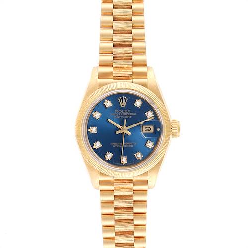 The image shows a front view of a Rolex President model watch with a gold band and blue dial with diamond hour markers.