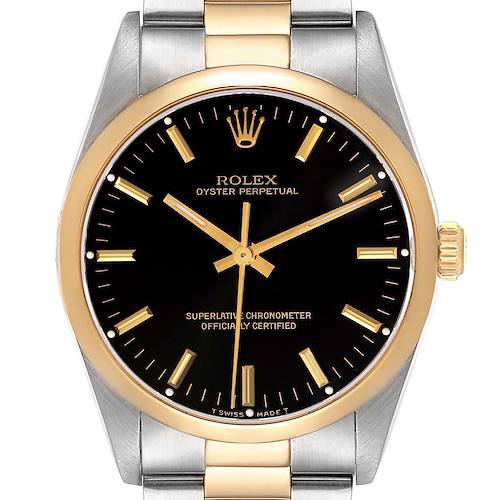 The image shows a front view of the Rolex Oyster Perpetual watch, highlighting its black dial, gold bezel, and two-tone bracelet.