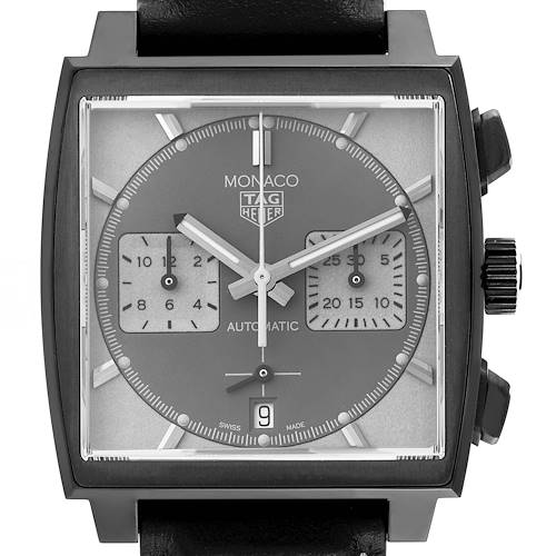 The image shows a front view of a Tag Heuer Monaco watch, displaying the face, hands, subdials, date window, and crown.