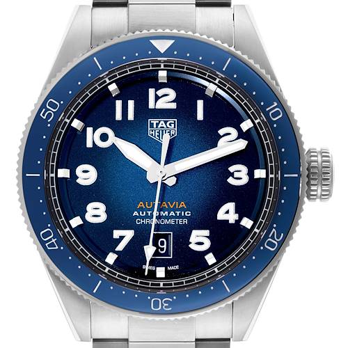 The Tag Heuer Autavia watch is shown from a front angle, highlighting its blue dial, bezel, and stainless steel bracelet.