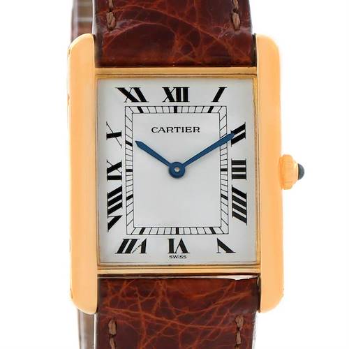 This image shows a Cartier Tank Classic watch from a front angle, highlighting its dial, Roman numerals, gold case, and brown leather strap.