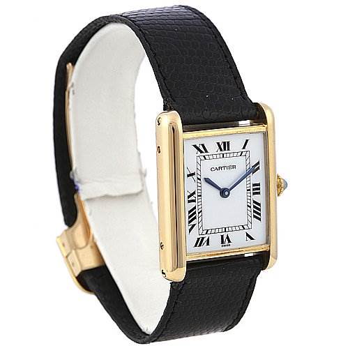 The image shows a Cartier Tank Classic watch from a three-quarter angle, highlighting the face, hands, strap, and buckle.