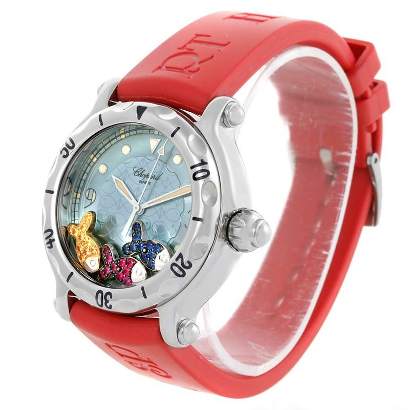 The Chopard Happy Fish Floating Rubi Sapphire Rubber Watch 288347-8402 is shown from a front-side angle, highlighting its red band and dial.