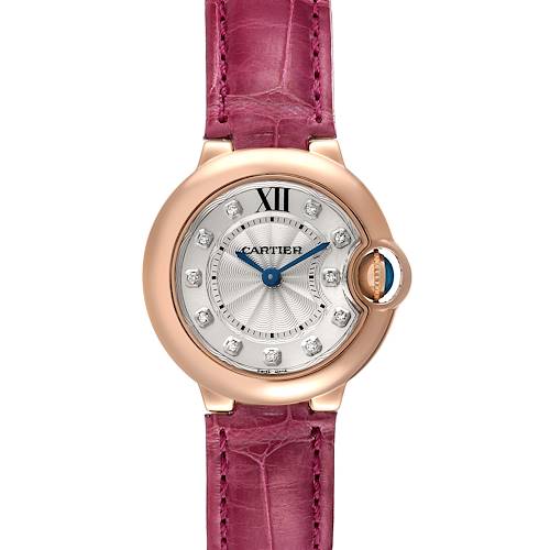 The image shows a close-up, front view of a Cartier Ballon Bleu watch with a pink strap and diamond markers.