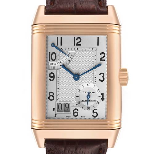 The Jaeger-LeCoultre Reverso watch is shown front-on, highlighting its rectangular face, dial, crown, and leather strap.